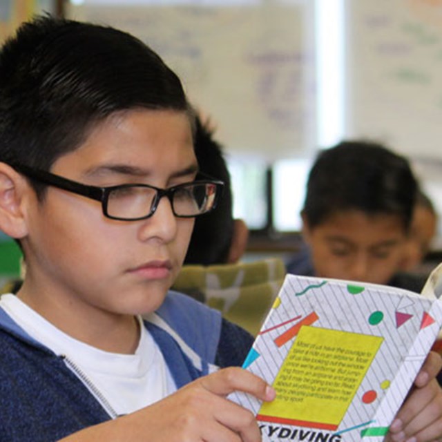 Scholars explore different worlds through reading.